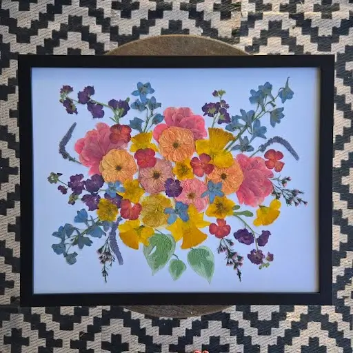 A bright garden bridal bouquet, pressed and framed in black